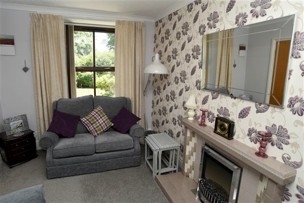 lounge overlooks the garden at Llwyn Beuno-llynholidays.wales